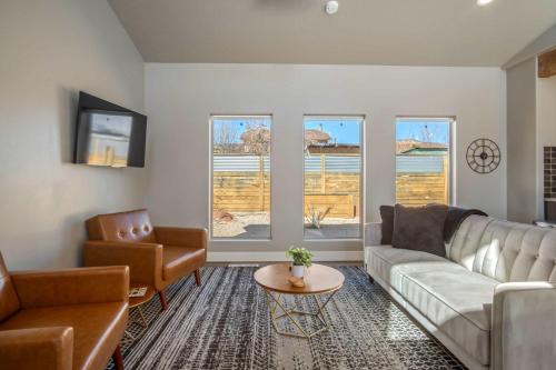 a living room with a couch and a table at Timber & Tin G 2Bed 2Bath w Pool & Rooftop Deck in Kanab