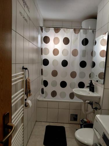 a bathroom with a polka dot shower curtain and a sink at LOBO stan na dan in Lukavica