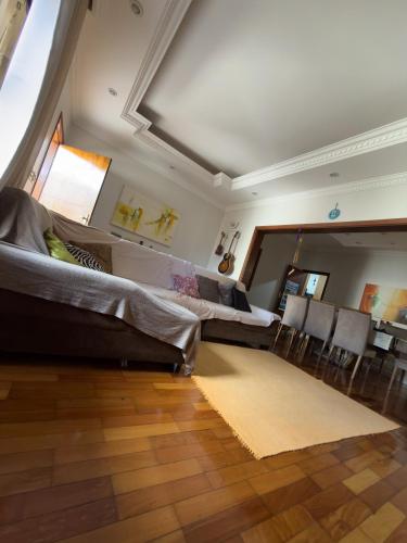 a living room with couches and a table and chairs at Hostel Muarama in Passos