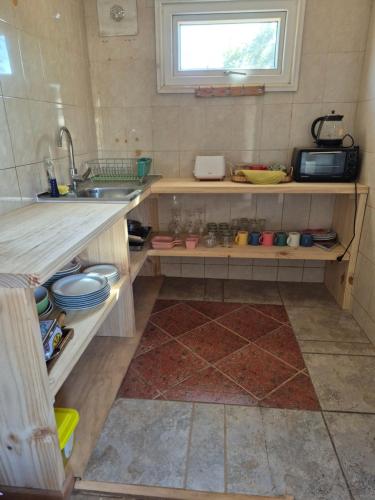 a small kitchen with a sink and a window at Casa Montes Valle Alegre in Quintero