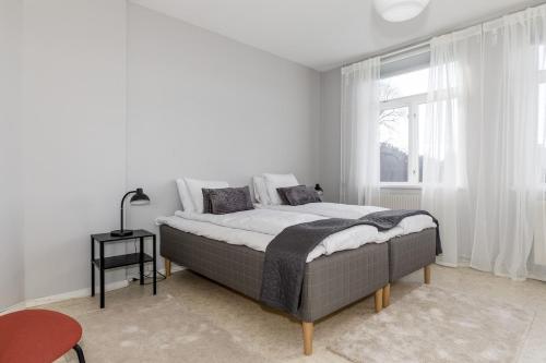 a white bedroom with a bed and a window at Functional and Spacious Apartment in Kopparberg in Kopparberg