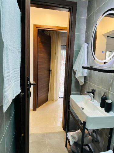 a bathroom with a sink and a mirror at Aski house - Authentic Cretan life by Hostinous in Askoí