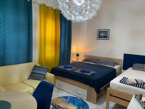 a bedroom with two beds and a couch and a chandelier at Villa Ante Blace in Blace