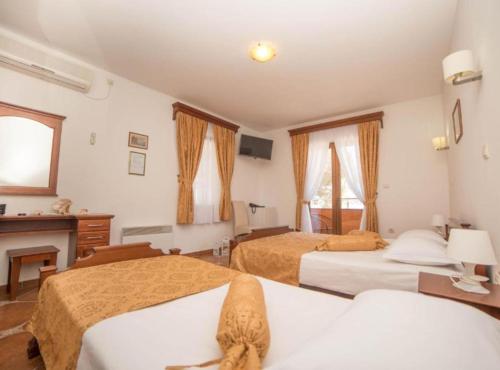 a hotel room with two beds and a fireplace at Fiammanti Hotel Montenegro in Herceg-Novi