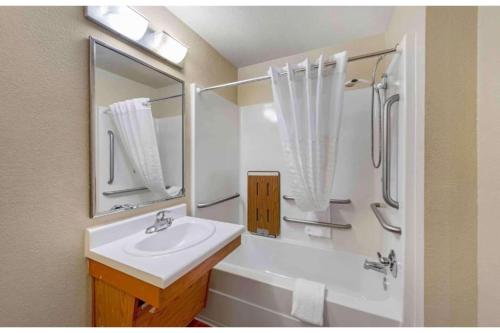 a white bathroom with a sink and a shower at Studio 6 Extended Stay Birmingham Pelham AL in Pelham
