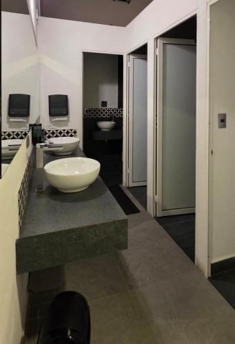 a bathroom with two sinks and a large bowl sink at Morada Luna Coyoacán in Mexico City