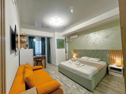 a bedroom with a large bed and a couch at Mamaia-NordCom Apartamente Exclusiviste S Resort 1 CBN la plaja Azimuth in Mamaia Sat/Năvodari