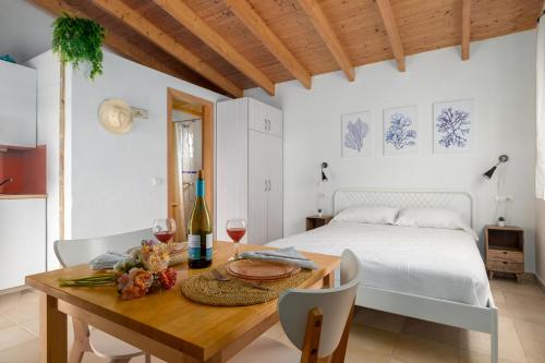 a bedroom with a bed and a table with wine glasses at Casa Garrover - Calma entre Sabinas in Illes Balears