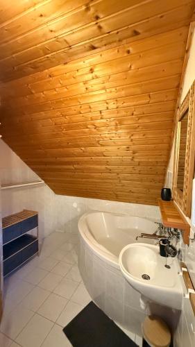 a bathroom with a white tub and a sink at Domeček Karlov in Malá Morávka