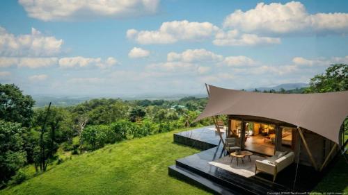 a house on a hill with a large roof at Auralta Rio Celeste I Elohi Collection in Rio Celeste