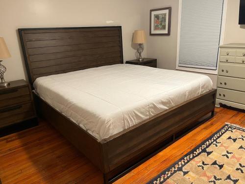 a bedroom with a large bed and a dresser at Downtown house w on-site parking walk to museums, US Capital Scap in Washington, D.C.