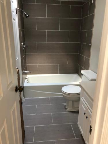 a bathroom with a white tub and a toilet at Downtown house w on-site parking walk to museums, US Capital Scap in Washington, D.C.