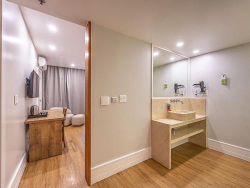 a bathroom with a sink and a mirror at B&B HOTEL Rio Copacabana Forte in Rio de Janeiro