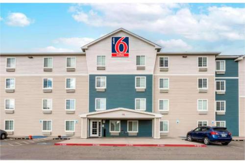 a large hotel with a car parked in a parking lot at Studio 6 Extended Stay El Paso East TX in El Paso
