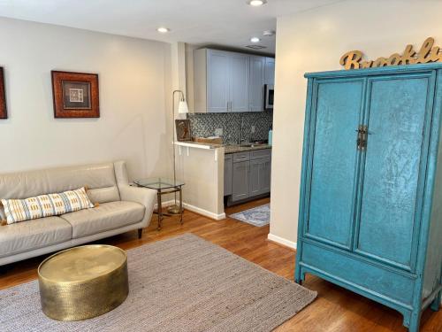 a living room with a couch and a blue cabinet at Downtown House Free On-site Parking A in Washington, D.C.