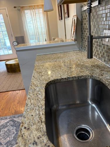 a kitchen sink with a granite counter top at Downtown House Free On-site Parking A in Washington, D.C.