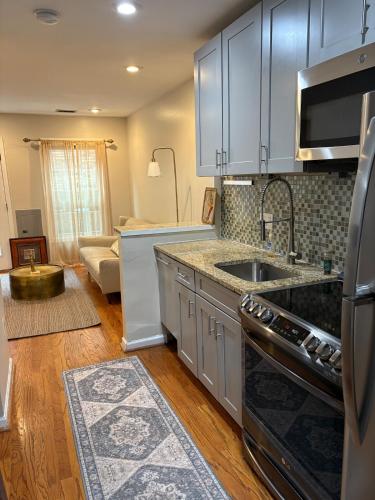 a kitchen with a sink and a stove top oven at Downtown House Free On-site Parking A in Washington, D.C.