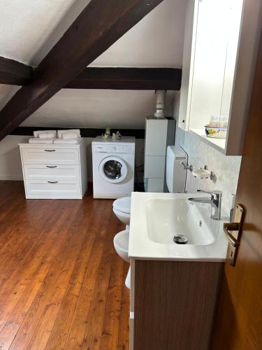 a bathroom with a sink and a washing machine at Tino Brezza di Mare in Deiva Marina