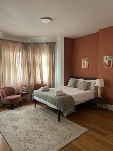 a bedroom with a large bed and a rug at Zozy Gladstone in London