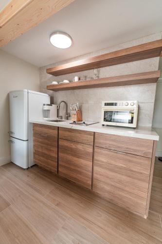 a kitchen with a white refrigerator and a microwave at Seahorse Beach Bungalows in Fort Pierce