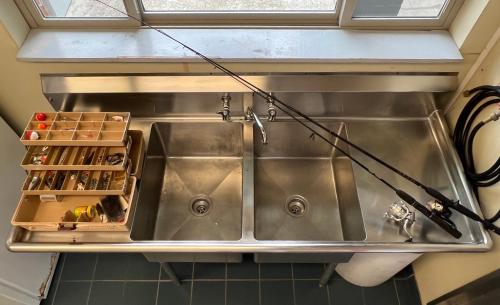 a sink in a kitchen with some bottles at The Tillamook Inn in Tillamook
