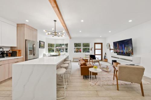 a kitchen and living room with a bar and chairs at Havana House Miami in Miami
