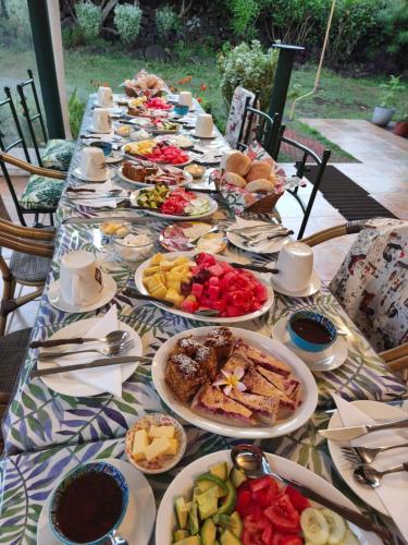 a long table with plates of food on it at Hostal Uruhao in Hanga Roa