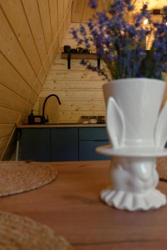 a white vase sitting on a table with a vase at Skala House in Skole