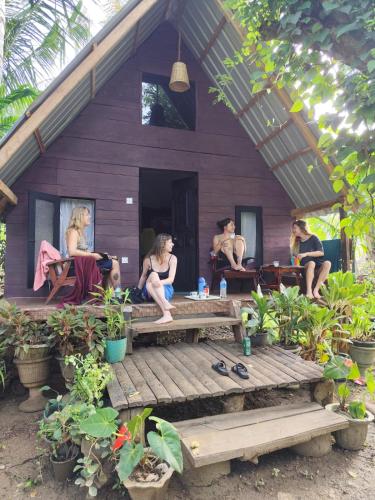 a group of people sitting outside of a cabin at Brooklyne Jungle Nest in Udawalawe