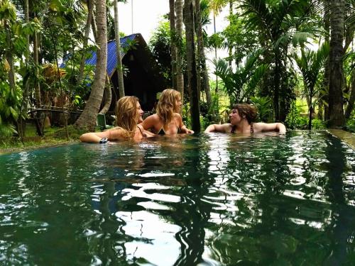 a group of three women in a swimming pool at Brooklyne Jungle Nest in Udawalawe