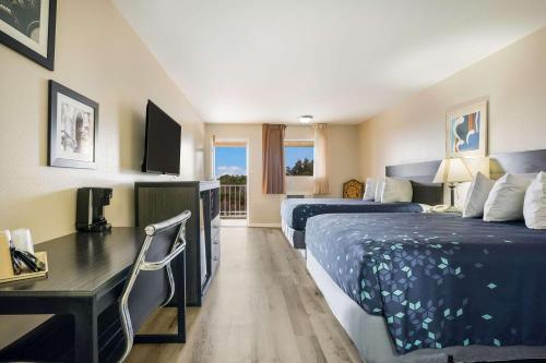 a hotel room with two beds and a desk at Americas Best Value Inn Refugio in Refugio