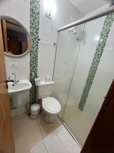 a bathroom with a toilet and a glass shower at Hotel Stela - A 2 min do Metrô Paraíso e Poucos Passos da Av Paulista in São Paulo