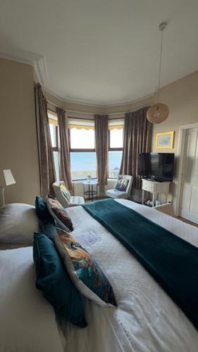 a bedroom with a large bed with a view of the ocean at Dacara Bed & Breakfast in Newcastle
