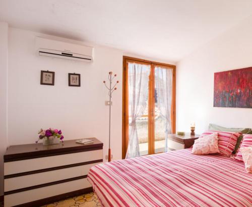 a bedroom with a bed and a window at La Casa di Teresa in Scalea