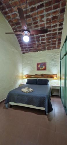 a bedroom with a blue bed with a ceiling at Cabañas Rancho Unelen in Colón