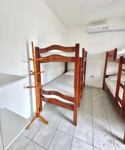 a small room with two bunk beds in it at Anexo Térreo - Pousada Cannã in Recife