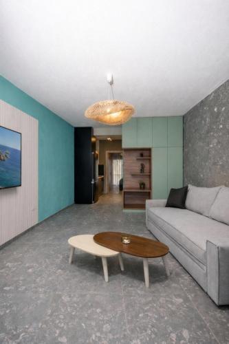 a living room with a couch and a table at MARTINI APARTMENTs in Nikiti