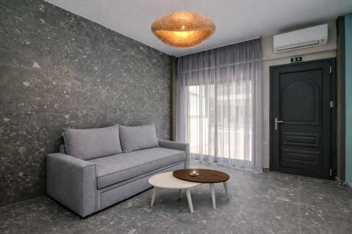 a living room with a couch and a table at MARTINI APARTMENTs in Nikiti