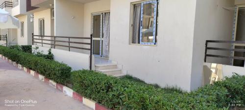 a white building with stairs and a window at الساحل الشمالى قرية جوليانا أمام قرية قناة السويس North Coast Juliana Resort Vip Chalet in Dawwār Muşādif Yūnus