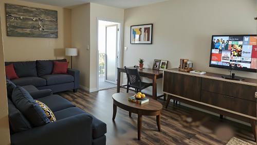 a living room with a couch and a tv at Resort-Style Family Getaway in Santa Monica in Los Angeles