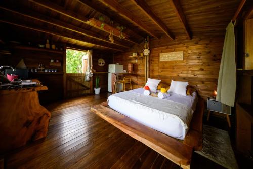 a bedroom with a bed with two teddy bears on it at Le jardin de Védèze in Les Abymes