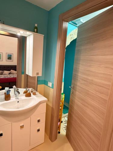 a bathroom with a sink and a mirror at La Casa di Lili in Nardò