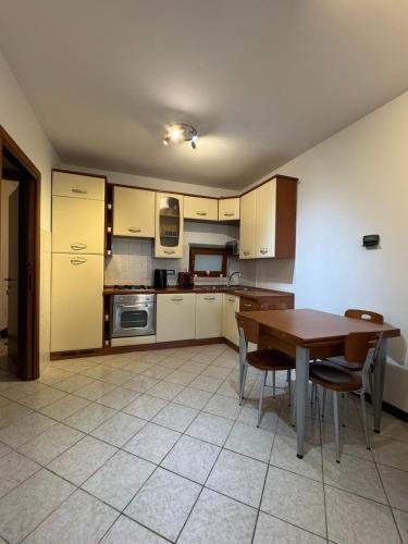 a kitchen with a wooden table and chairs in it at Volpes home in Desenzano del Garda