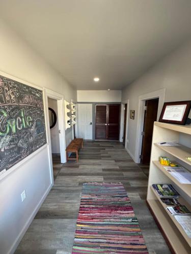 a hallway with a chalkboard on the wall and a rug at Germantown Inn & Lounge in Hermann