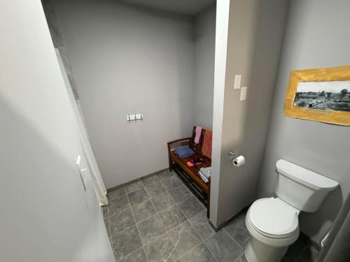 a bathroom with a toilet and a painting on the wall at Germantown Inn & Lounge in Hermann
