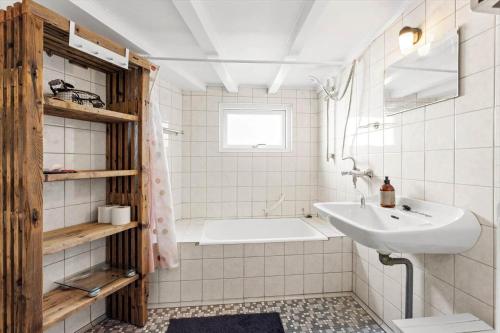 a white bathroom with a tub and a sink at AE324-Marstal-Kirkestraede-31 in Marstal