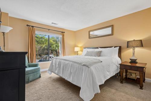 a bedroom with a bed and a window at 803 Clipper Court in Hilton Head Island
