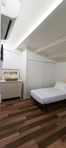 a bedroom with a bed and a dresser at ACASADETEO in Padrón