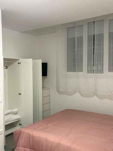 a bedroom with a pink bed and a window at sweet rest in Castel Maggiore