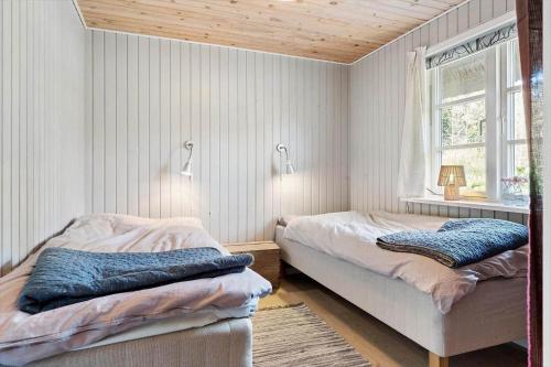 a bedroom with two beds and a window at 2010-Romo-Moritzvej-10 in Høm